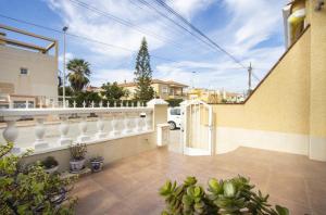a house with a white fence and some plants at Casa Vera in Torrevieja