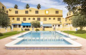 a swimming pool in front of a building at Casa Vera in Torrevieja