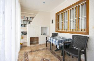 a dining room with a table and chairs and a window at Casa Vera in Torrevieja