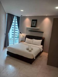 Ένα ή περισσότερα κρεβάτια σε δωμάτιο στο VORTEX SUITES KLCC by MSF +30 φωτογραφίες
