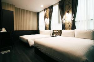 Postel nebo postele na pokoji v ubytování LIHO Hotel Hankou
