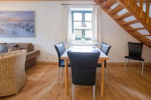 a dining room with a table and chairs at Haus Schünemann 4 in Kellenhusen