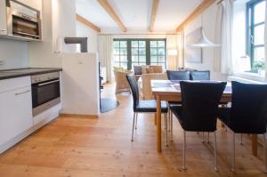 a kitchen and dining room with a table and chairs at Haus Schünemann 4 in Kellenhusen