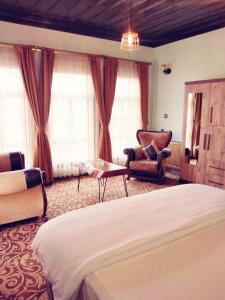 a bedroom with a bed and a chair and a table at Kayıbeyi Hotel & Restaurant in Bursa +39 photos