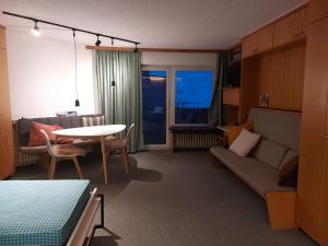 a living room with a couch and a table at LogementVals in Vals