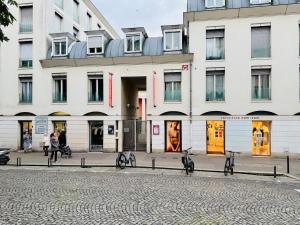 a large white building with bikes parked in front of it at Charmant cocon au cœur de Montmartre in Paris