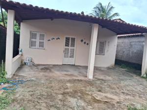 a white house with birds on the wall at Kasa Morro Branco in Beberibe