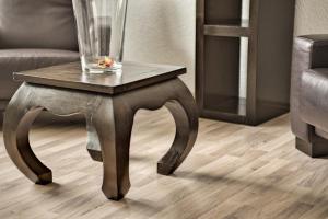 a wooden table with a glass vase on top of it at City Ferienwohnung Gaggenau in Gaggenau