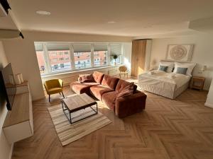 a living room with a couch and a bed at morand I Apartments in Salzburg