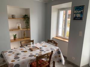 a dining room with a table and a window at SEJOUR AU COEUR DES VOLCANS in Saint-Ours +6 photos