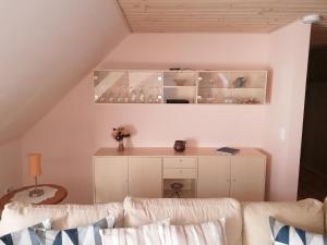 a living room with a couch and a desk at Fewo Skjærnsøde in Gøttrup
