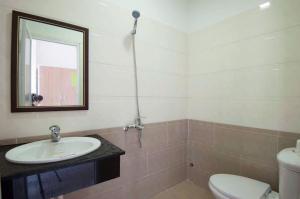 a bathroom with a sink and a toilet and a mirror at Bong House Homestay in Hoi An +92 photos
