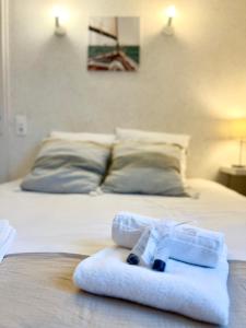 Una habitación de hotel con una cama con una toalla encima. en La Côtière, Terrasse et Jardin RDC, Proche plage, en Saint-Palais-sur-Mer