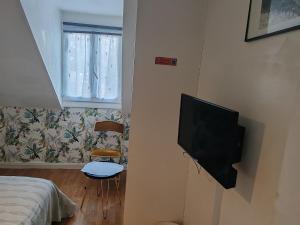 a bedroom with a flat screen tv on a wall at GITE Chez Marilou in Aulnay-sous-Bois