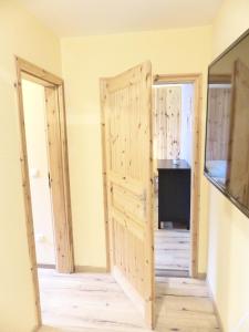 a room with two wooden doors and a television at Ferienwohnung Sonne in Walsrode +4 photos