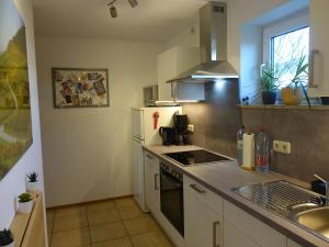 a kitchen with a sink and a stove top oven at Exclusive kuschelige Wohnung im Herzen FrankensEuropa in Gaukönigshofen +9 photos