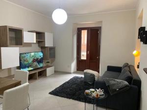 a living room with a couch and a tv at La Terrazza di Finuzzu in Rende