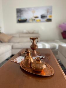 un tavolo con tre teiere sopra un tavolo di At Teo's a Durrës