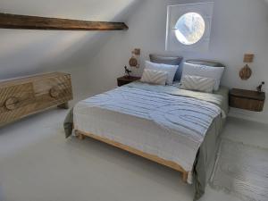 ein Schlafzimmer mit großem Bett und Fenster in der Unterkunft La petite maison blanche in Dunkerque