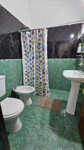 a bathroom with two toilets and a shower curtain at El Cañaveral in Capilla del Monte +56 photos