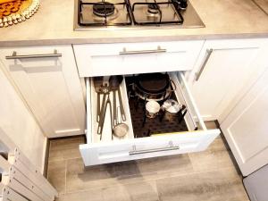 an open drawer in a kitchen with a stove at Orion's Moon in Las Eras