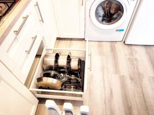 a kitchen with a dishwasher and a washing machine at Orion's Moon in Las Eras +31 photos