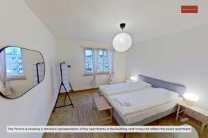 a bedroom with a bed and a mirror and a tripod at Basic 2BR with Natural Light in Zürich