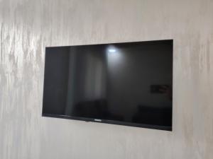 a flat screen tv hanging on a wall at Al Wesam Furnished Apartments in Aqaba