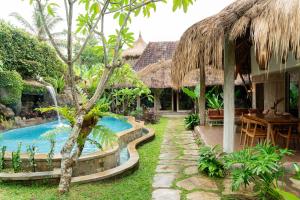 a resort with a swimming pool in the yard at Puri Samaira in Tanjung