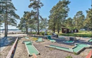 a playground with green slides in a park at Vakker leilighet i Åros in Søgne