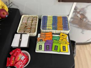 a table with two trays of toys and some donuts at Hotel RICHMOND Punta del Este in Punta del Este +14 photos