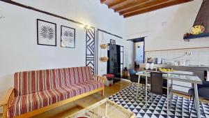 a living room with a couch and a table at Finca Paraiso Casa Rural Tenerife Ecoturismo in Las Lagunas