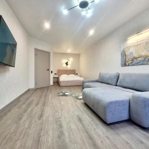 a living room with a couch and a bed at ApartPoltava Перлина біля Мюнхена РЕМОНТ 2025 in Poltava