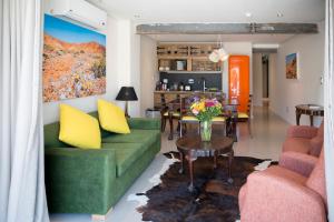 a living room with a green couch and a table at Cape Heritage Hotel in Cape Town