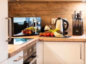 a kitchen with a plate of vegetables on a counter at FeWo Prora - Dünenheide 3.3 in Binz