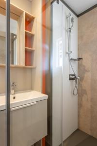 a bathroom with a shower and a sink at Düne 46 in Scharbeutz +17 photos