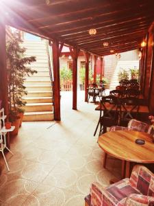 a patio with tables and chairs and tables and tablesearcher at Kayıbeyi Hotel & Restaurant in Bursa