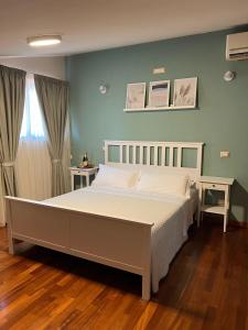 sypialnia z dużym łóżkiem z białą pościelą w obiekcie SIGIS HOTEL - Fiumicino w mieście Fiumicino