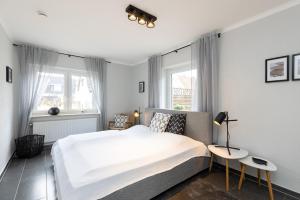 Postel nebo postele na pokoji v ubytování Appartement Merle Kieler Straße 16a APPARTO Grömitz