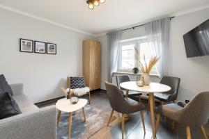 TV a/nebo společenská místnost v ubytování Appartement Merle Kieler Straße 16a APPARTO Grömitz