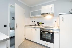 Kuchyň nebo kuchyňský kout v ubytování Appartement Merle Kieler Straße 16a APPARTO Grömitz + 17 fotografií