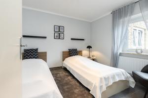 Postel nebo postele na pokoji v ubytování Appartement Merle Kieler Straße 16a APPARTO Grömitz
