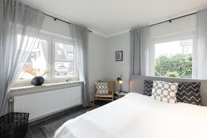 Postel nebo postele na pokoji v ubytování Appartement Merle Kieler Straße 16a APPARTO Grömitz