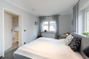 Postel nebo postele na pokoji v ubytování Appartement Merle Kieler Straße 16a APPARTO Grömitz