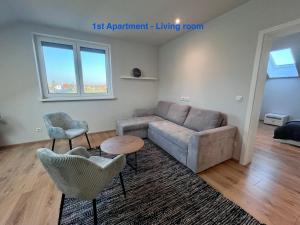 a living room with a couch and two chairs at Cozy Apartment near Vienna Airport in Schwechat