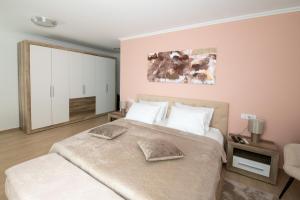 a bedroom with a large bed with white pillows at Villa Angela in Šmrika +48 photos
