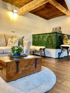 a living room with a couch and a coffee table at Fairytale cottage Francka in Gorica pri Slivnici