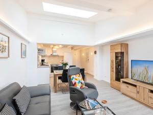 ein Wohnzimmer mit Couch und Flachbildfernseher in der Unterkunft FeWo Prora - Ausblick in Binz