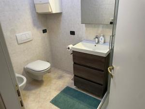 a small bathroom with a toilet and a sink at La Mansarda di Pinocchio e dei Lego in Bologna