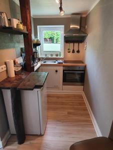 a small kitchen with a sink and a stove at Ferienwohnung "Unner Deck" in Sahrensdorf